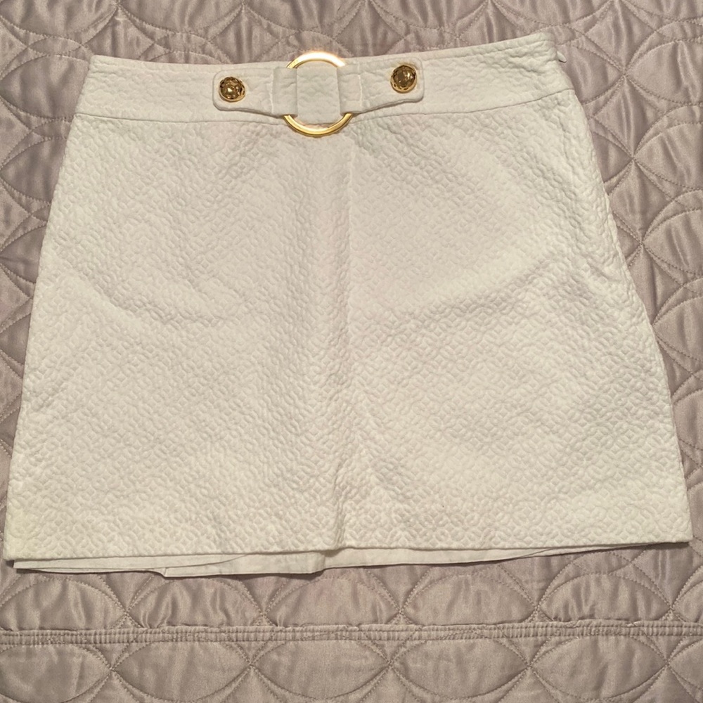 White skirt with gold hardware above the knee sold as is.